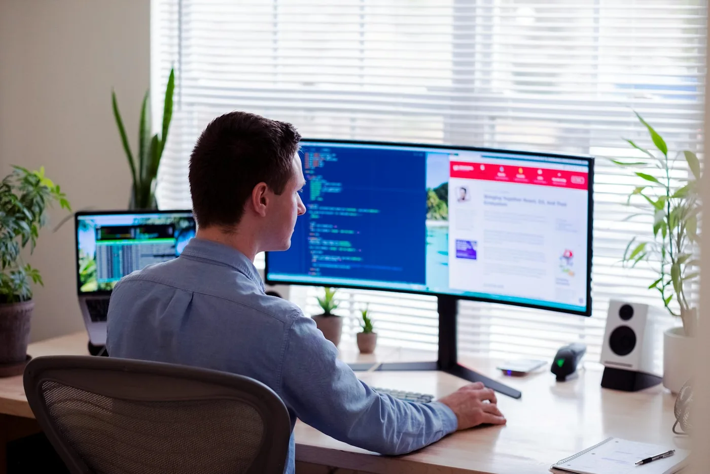 Engineer working at a desk with a large monitor